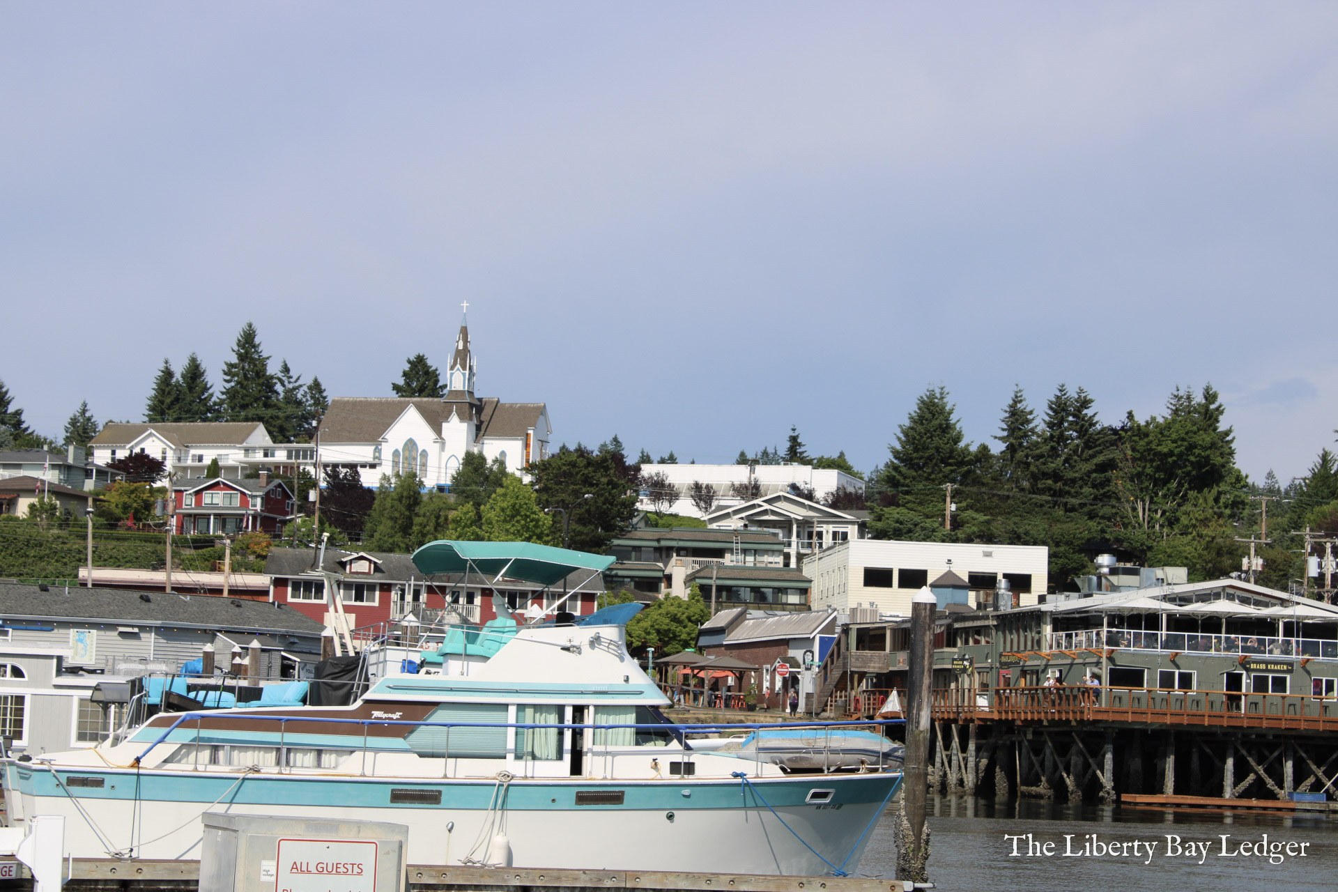 The waterfront at the Port of Poulsbo, with the church steeple on the hill above town.
